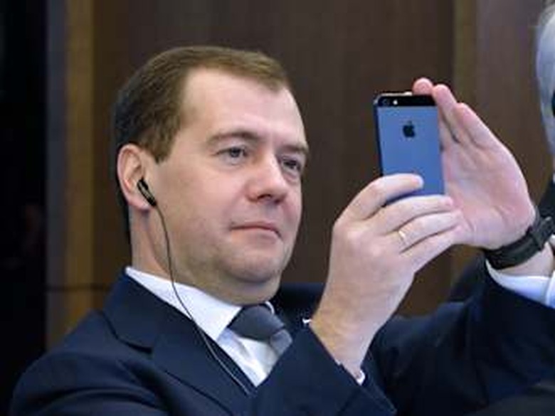 Russian Prime minister Dmitry Medvedev takes a picture of the Eiffel Tower with his smartphone during a meeting, on November 27, 2012, at French employers association MEDEF's headquarters in Paris. AFP PHOTO ERIC FEFERBERG (Photo credit should read ERIC FEFERBERG/AFP/Getty Images)