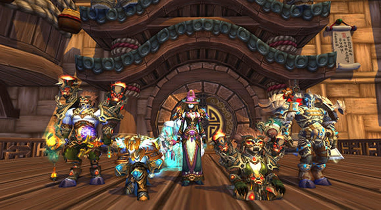 A group of characters wearing challenge mode gear, from left to right: draenei shaman, human paladin, draenei mage, pandaren shaman, draenei death knight