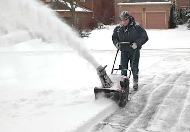 man working with a snow blowing ...