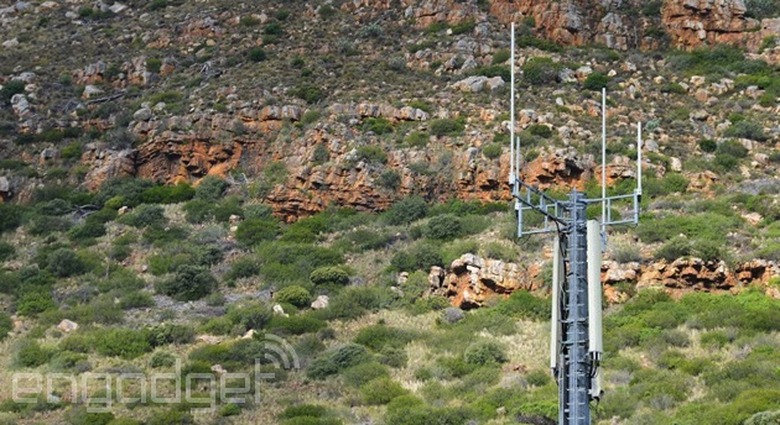 A cell tower stands alone in the desert