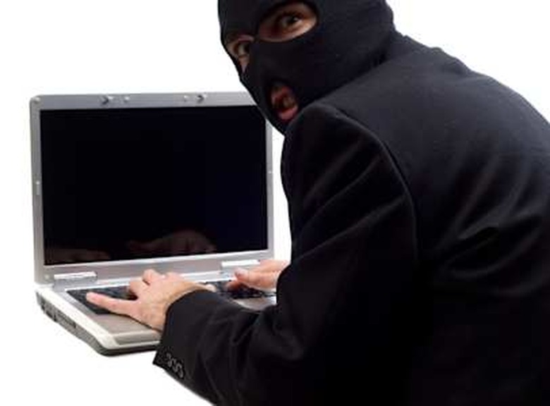 a hacker is using a laptop...