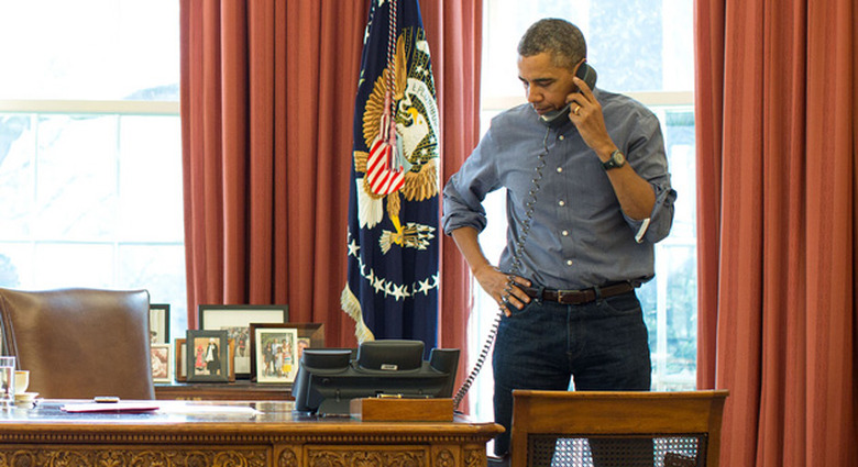 President Obama takes a phone call in the Oval Office