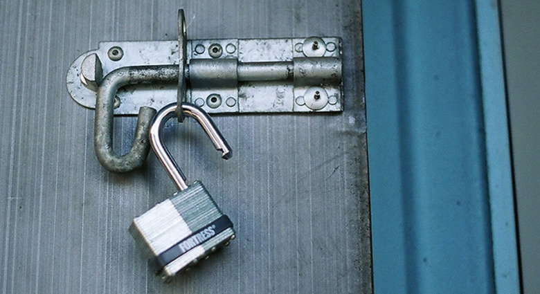 Open padlock on a door