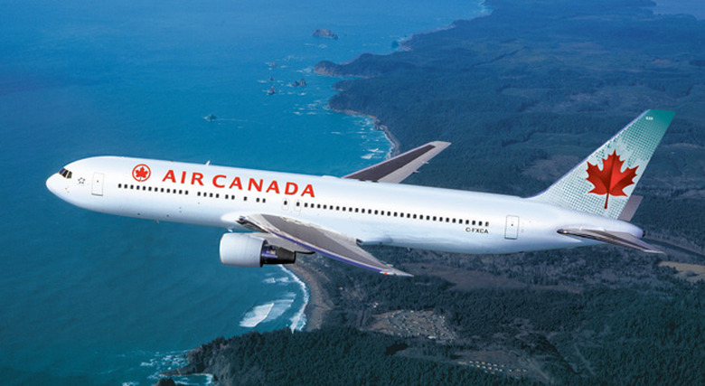 Air Canada aircraft flying over the coastline