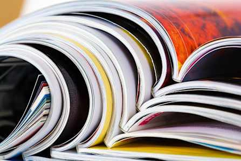 Closeup background of a pile of old magazines with bending pages