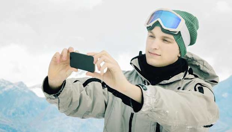 Skier taking a picture with his phone