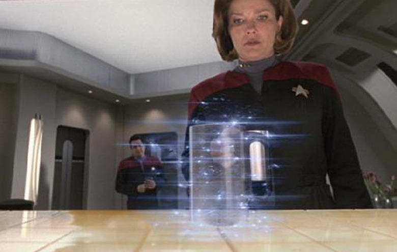 Captain Janeway waits impatiently for a replicator to finish