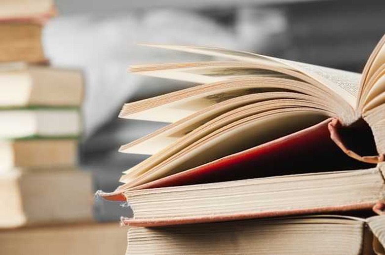 Open course books on a desk in a library