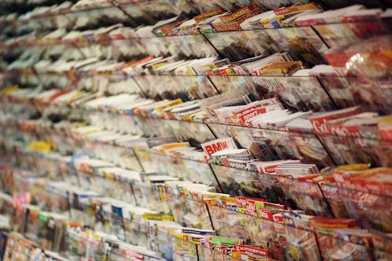 Magazines on book shelf.