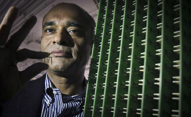 In this Thursday, Dec. 20, 2012, photo, Chet Kanojia, founder and CEO of Aereo, Inc., stands next to a server array of antennas as he holds an antenna between his fingers, in New York. Aereo is one of several startups created to deliver traditional media over the Internet without licensing agreements. Past efforts have typically been rejected by courts as copyright violations. In Aereoâs case, the judge accepted the companyâs legal reasoning, but with reluctance. (AP Photo/Bebeto Matthews)