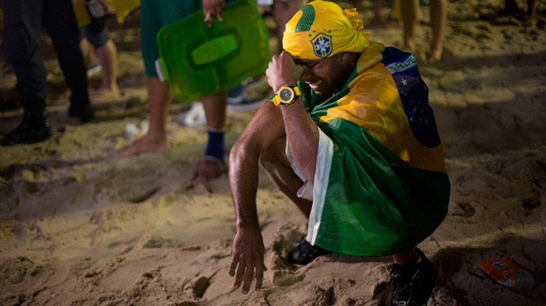 A Brazil fan cries as his team loses to Germany in the World Cup semi-final 