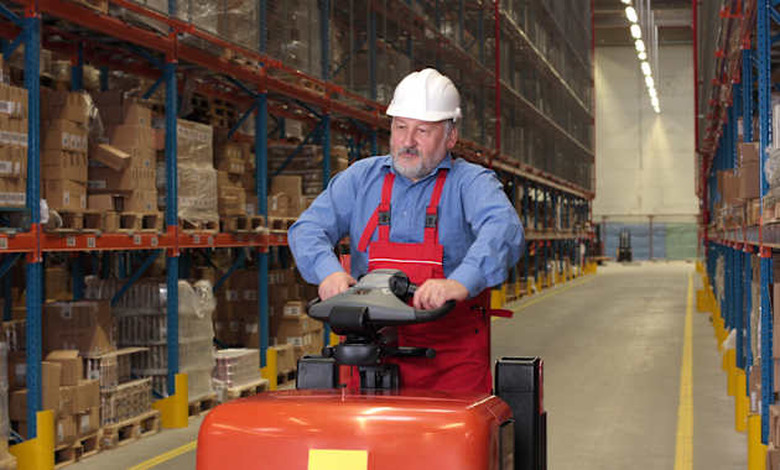 a senior worker driving the...