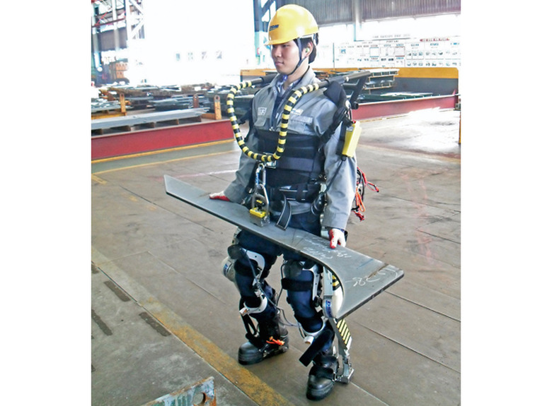 Daewoo shipyard worker carrying a heavy part