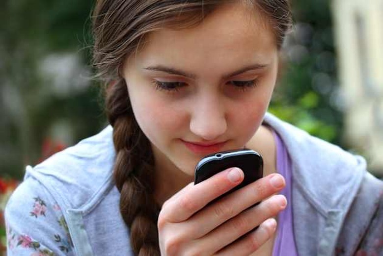 girl with a mobile phone reads...