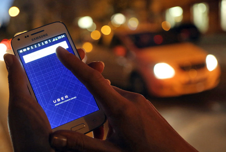 Hailing an Uber in front of The Enemy (aka a taxi)