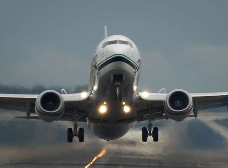 A passenger jet taking off from Washington D.C.'s Reagan National Airport. The runway is obscured by the blast fro the jet engi