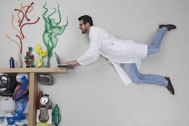 Young man doing experiment and using laptop