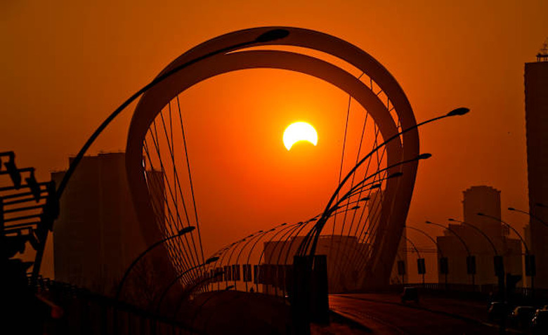 Partial solar eclipse at sunset moment