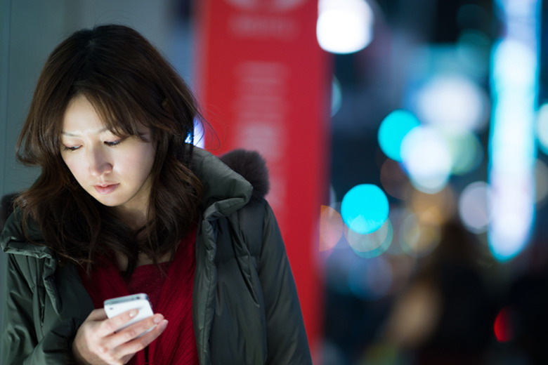 Concerned-looking woman using an iPhone