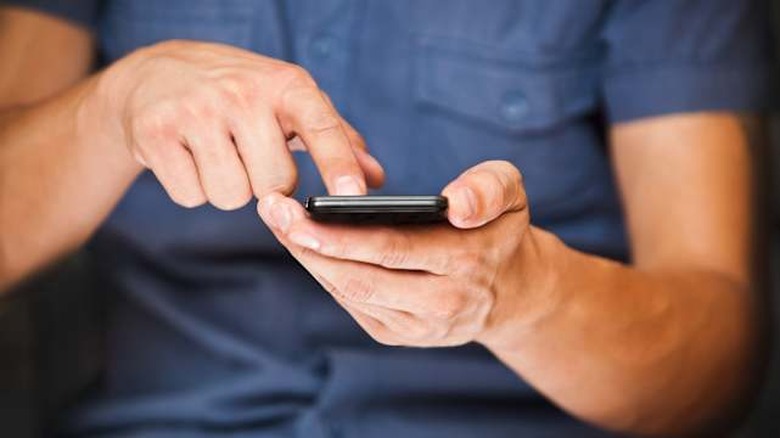 close up of a man using mobile...