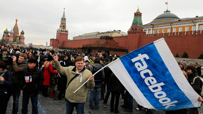 Protesters holding a Facebook flag in a Moscow protest