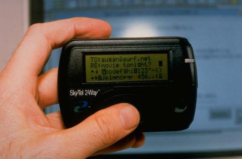 Hand holding SkyTel 2-Way alphanumeric (