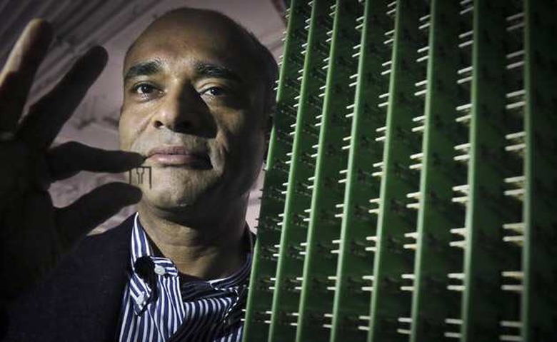 In this Thursday, Dec. 20, 2012, photo, Chet Kanojia, founder and CEO of Aereo, Inc., stands next to a server array of antennas as he holds an antenna between his fingers, in New York. Aereo is one of several startups created to deliver traditional media over the Internet without licensing agreements. Past efforts have typically been rejected by courts as copyright violations. In Aereoâs case, the judge accepted the companyâs legal reasoning, but with reluctance. (AP Photo/Bebeto Matthews)