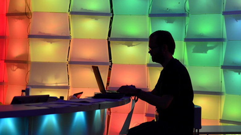 CCC convention goer works on a laptop