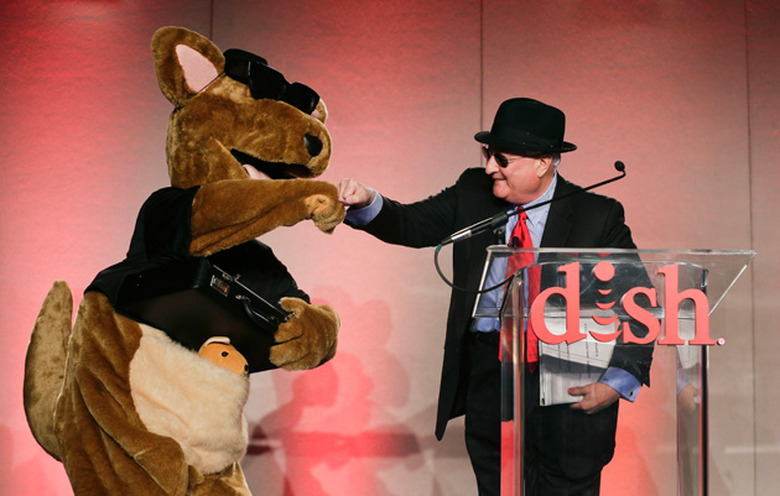 Dish CEO and his mascot share a fist bump