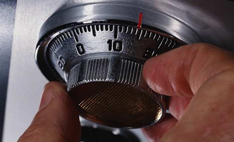 |black|business|business and transportation|center|closeup|color|combination lock|detail|dial|finger|hand|horizontal|interior|lo