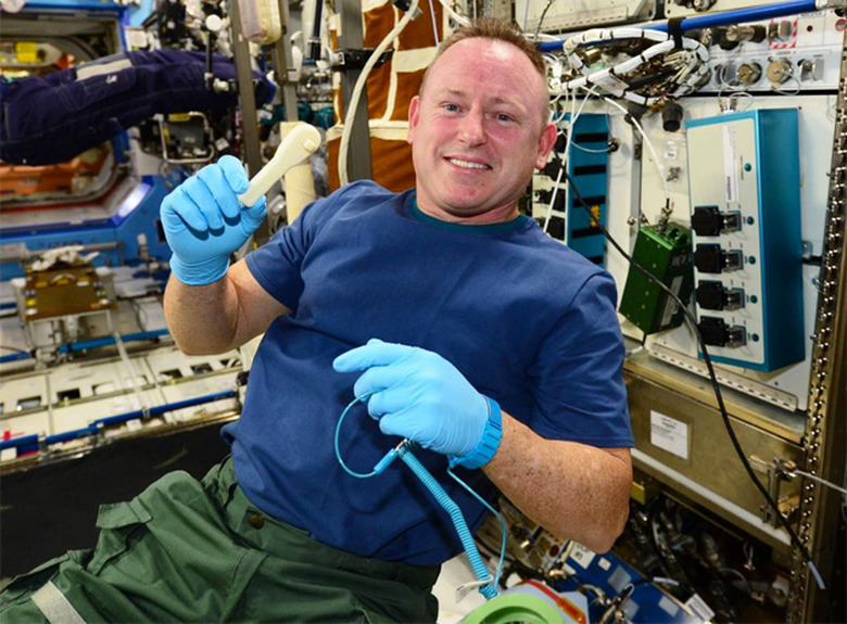 ISS Commander Butch Wilmore holds a 3D-printed ratchet