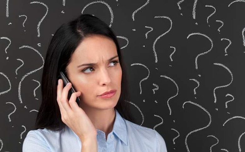 Mobile phone service concept - Woman on the phone with question marks on a blackboard.