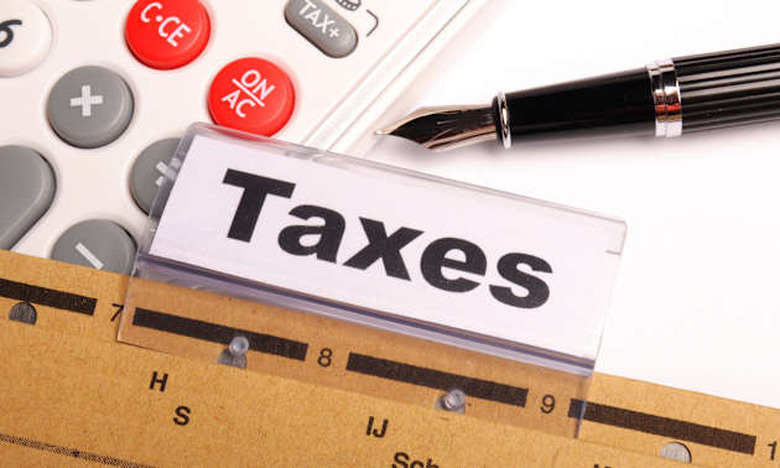 tax or taxes concept with word on business folder index