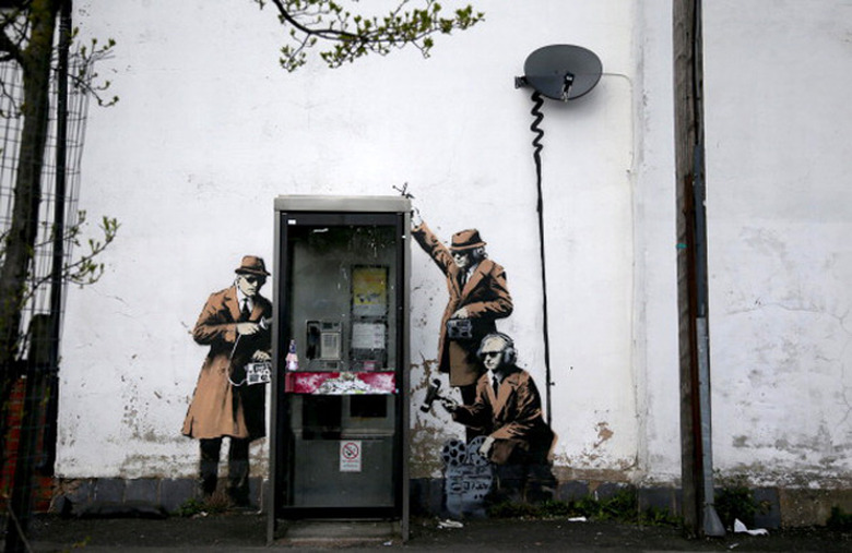 Reported Banksy graffiti showing eavesdroppers