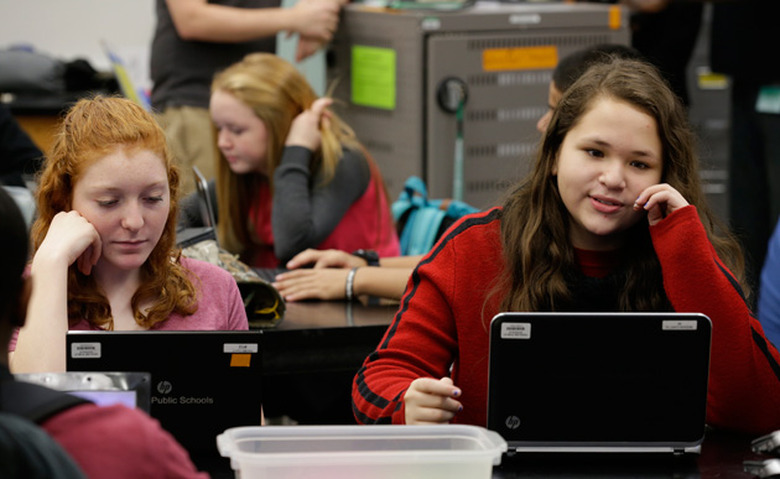 Students learning to code on laptops