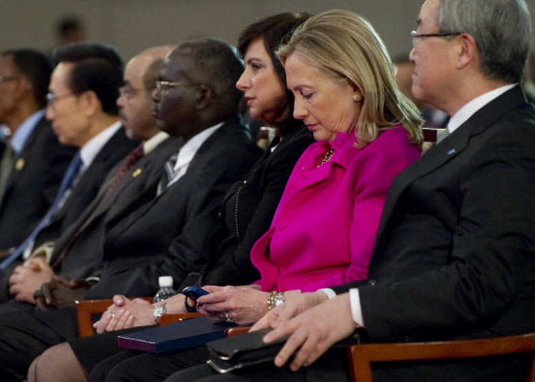 Hillary Clinton checks her BlackBerry