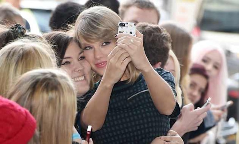 Picture Shows: Taylor SwiftOctober 09, 2014Pop sensation Taylor Swift seen arriving at the BBC Radio One studios in London, England.The 'Shake It Off' singer was wearing a checked top with a matching mini skirt over black tights and high-heeled ankle boots as she happily stopped to pose for photos with several eager fans.Non ExclusiveWORLDWIDE RIGHTSPictures by : FameFlynet UK Â© 2014Tel : +44 (0)20 3551 5049Email : info@fameflynet.uk.com
