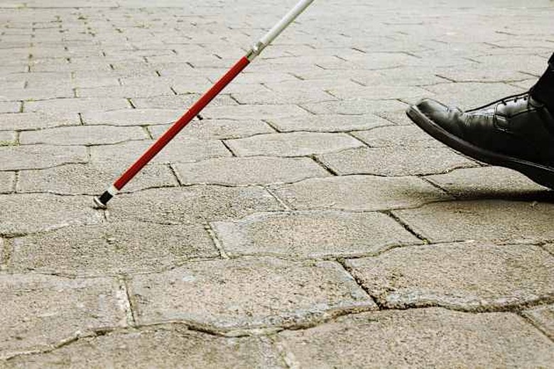 Closeup of Blind Man Walking With White Cane
