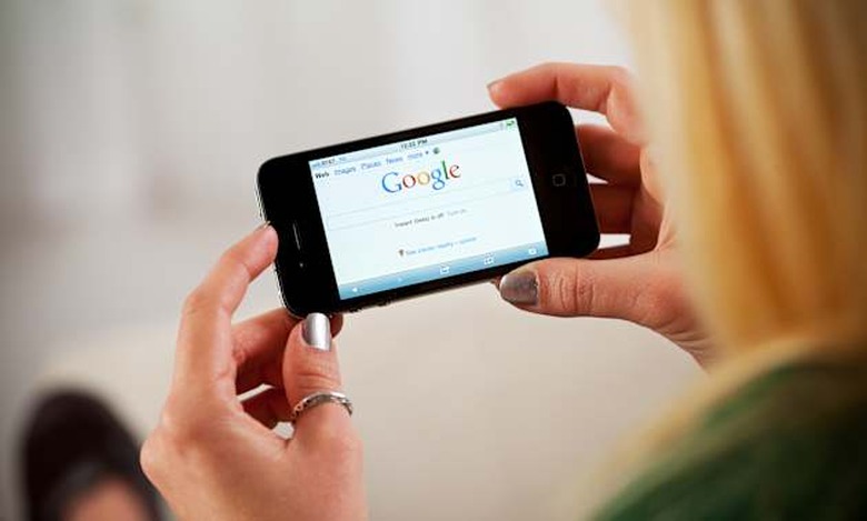 St. Louis, Missouri, USA - March 9, 2011: Woman Using Apple iPhone 4 To Access Google Website