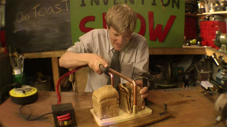 Colin Furze slices and toasts a loaf of bread