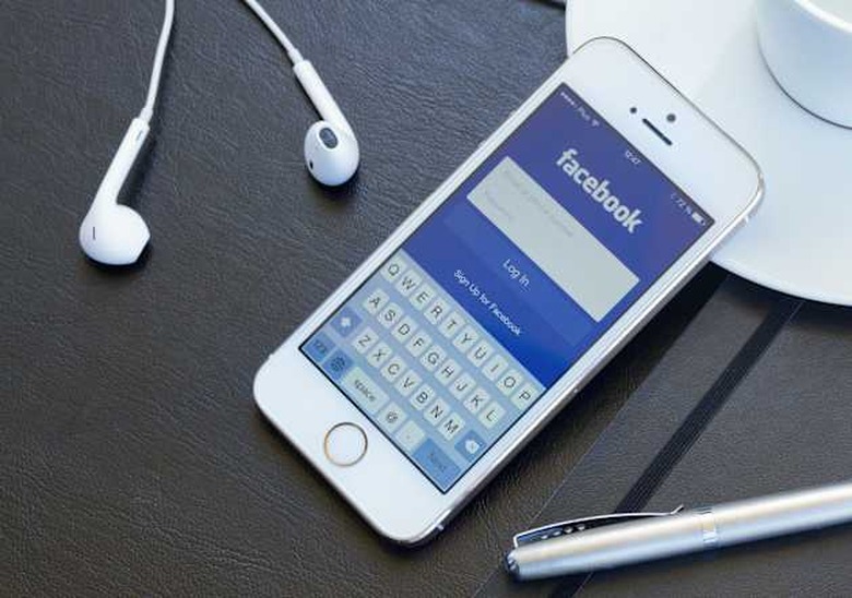 WARSZAWA, POLAND - APRIL 01, 2014: Loging in Facebook app on Iphone5s Facebook is the largest social network in the world. It wa