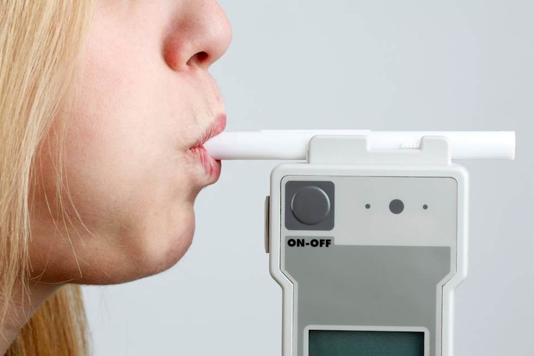 Woman Blowing in Breathalyzer