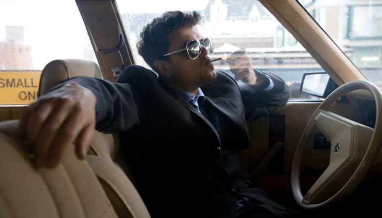 man wearing suite in a car smoking marijuana