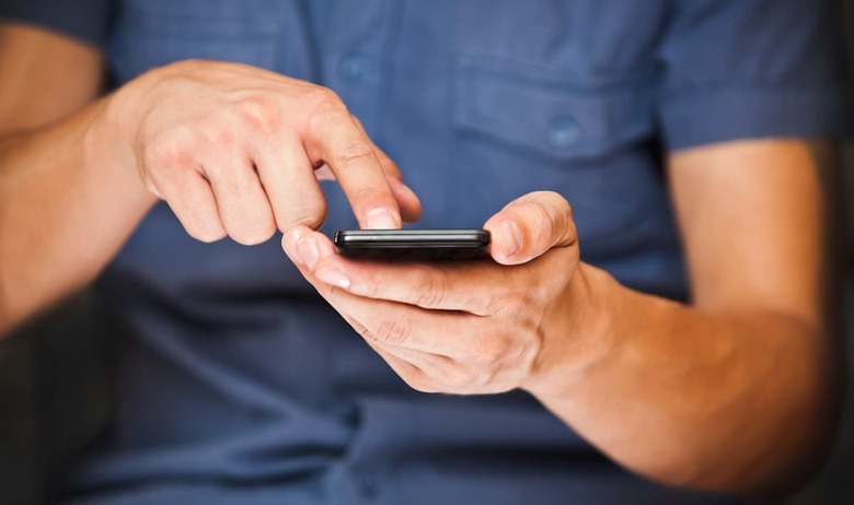 close up of a man using mobile...