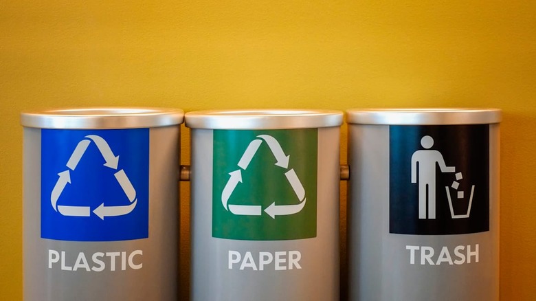 Recycling bins on yellow background