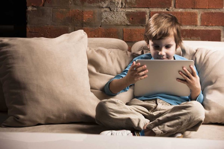Boy sitting with digital tablet