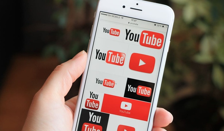 SARAJEVO , BOSNIA AND HERZEGOVINA - MAY 10 , 2015: Woman watch Youtube icons on Apple iPhone 6. YouTube is a video-sharing websi