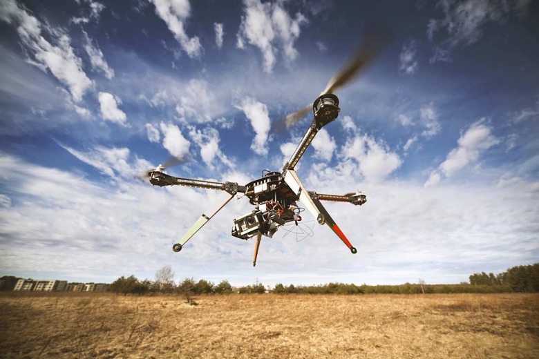 Flying drone is filming video in the blue sky