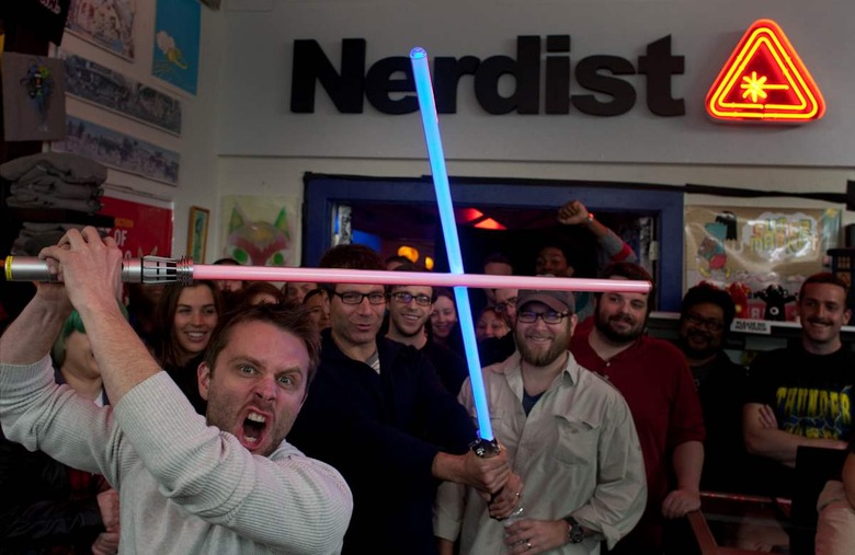 Comedienne Chris Hardwick, front, and Peter Levin pose with audience members in front of the Nerdis