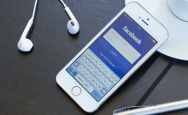 WARSZAWA, POLAND - APRIL 01, 2014: Loging in Facebook app on Iphone5s Facebook is the largest social network in the world. It wa
